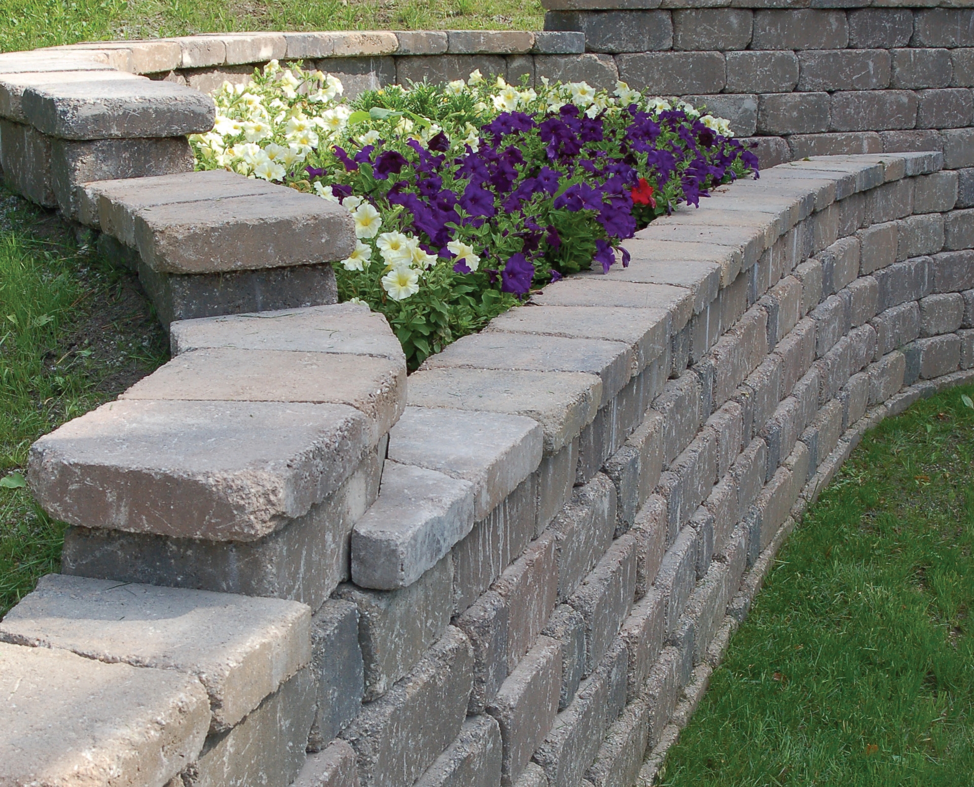 Keystone outdoor living installation with wall and patio